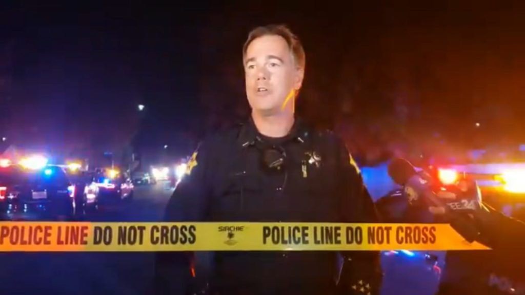 A police officer in Fresno, California, briefs the media on a shooting there on November 17, 2019.